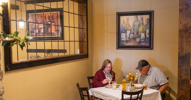Interior, diner table, corner, people eating