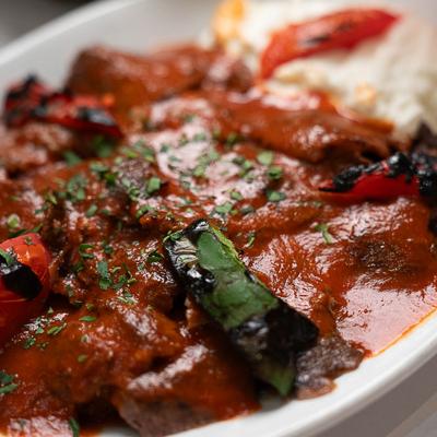 Kebab meat in tomato sauce.