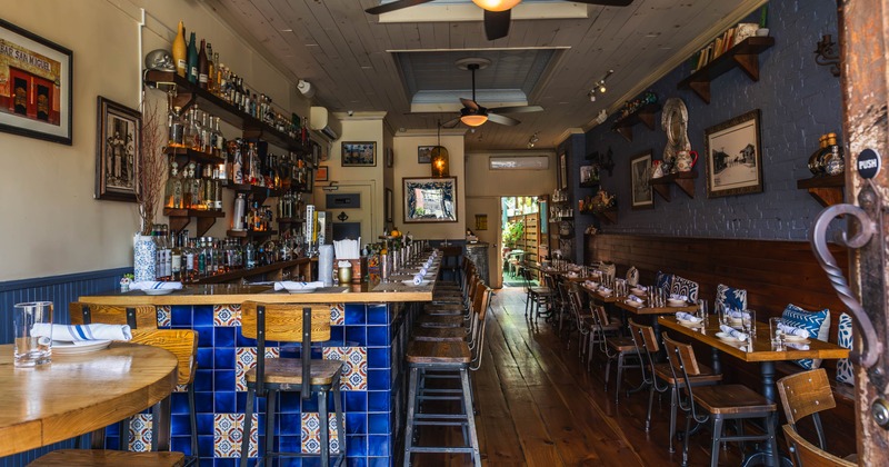 Interior seating area with a bar and dining tables