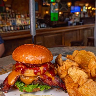 Paddy Burger with chips and a pickle on the side.