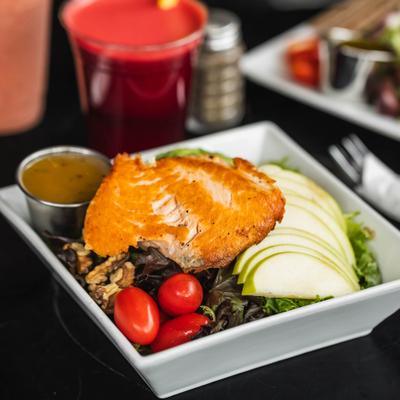 Salmon salad with sliced green apple, walnuts, and cherry tomatoes.