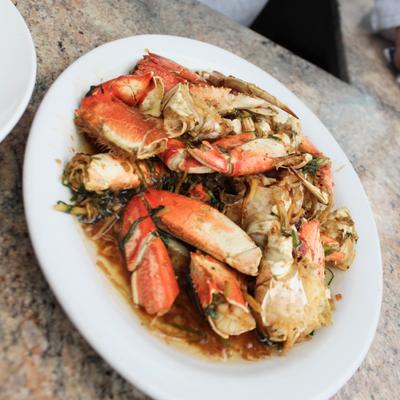 Crab legs in a light brown sauce.