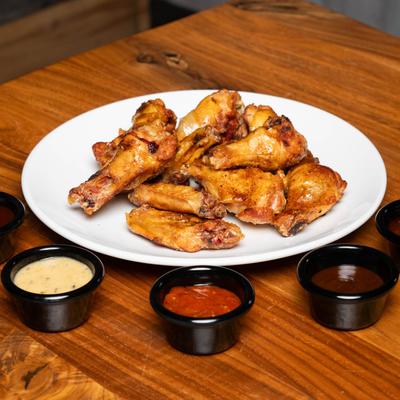 Smoked chicken wings, with dipping sauces.