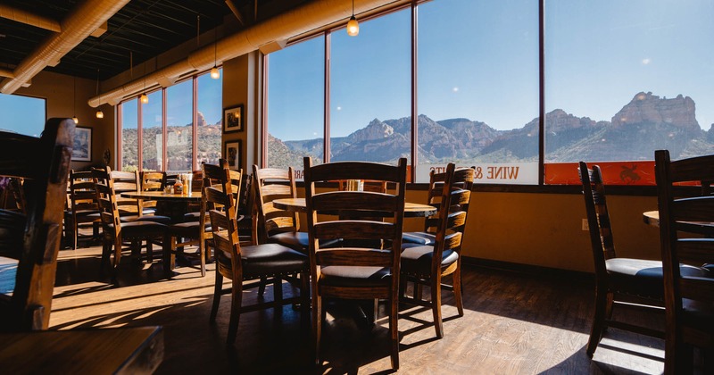 Interior, tables, chairs, a wide view of the hills