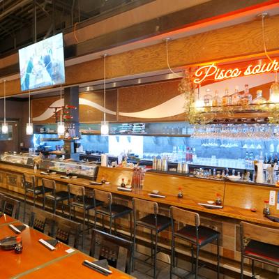 Interior featuring a well-stocked bar and counter seating.