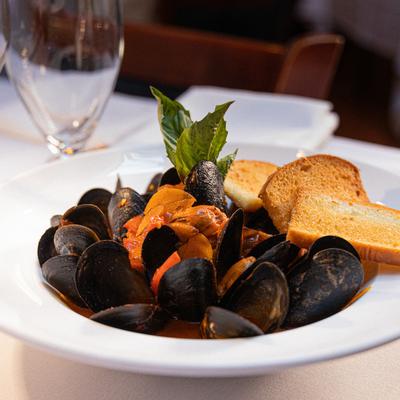 Steamed Mussels in spicy tomato sauce, served with toasted bread.