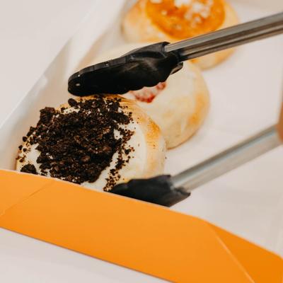 Baked pastry being packed in the box.