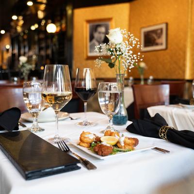 fried shrimp and oyster appetizer with glasses of wine.