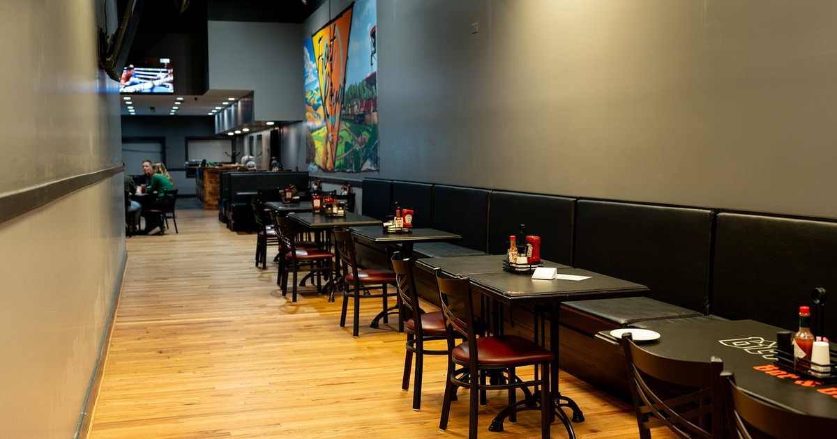 Interior space, lined up dining tables, chairs and upholstered seats