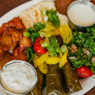 Vegetarian Combo Platter featuring stuffed grape leaves, tabbouleh salad and dips.