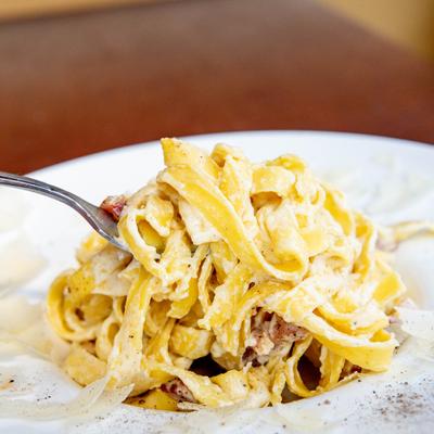 Carbonara with pancetta, creamy egg-based Alfredo sauce and black pepper