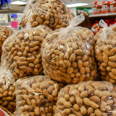 Packages of shelled peanuts stacked in a box.