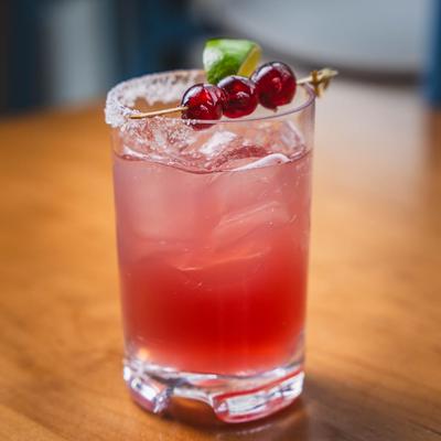 The Margarita garnished with a lime wedge and sour cherries.