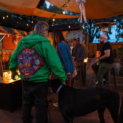 People in a seating area featuring a fire pit.