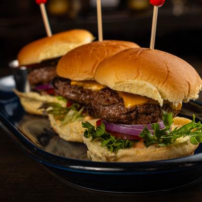 Three sliders on a black plate.