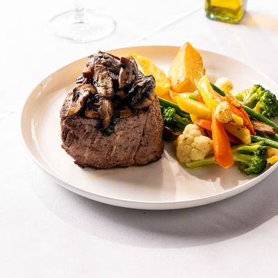 Filet Mignon, with mushrooms, roasted potatoes, and vegetables.