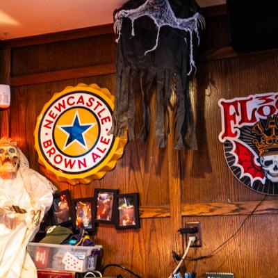 Interior decorated with various brewery signs and Halloween decorations.