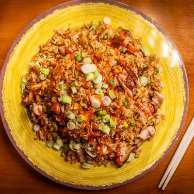 Fried rice with vegetables, scallions, and sauce.
