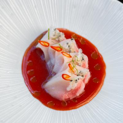 Hamachi Haru , crudo style dish with strawberry ponzu, yuzu gel, thai chili, and sesame rice crisp..