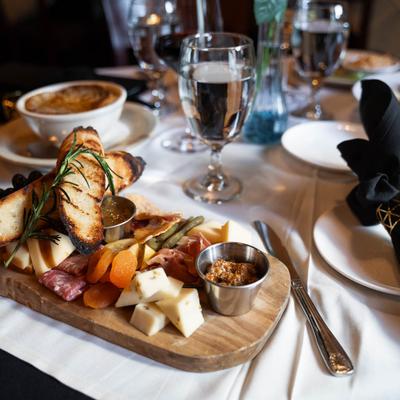 charcuterie board with water glasses.