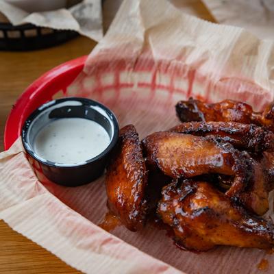 Smoked chicken wings in BBQ sauce, with blue cheese dressing.