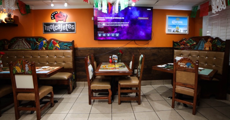 View at the booth with dinner setting on the table and restaurant's decorations