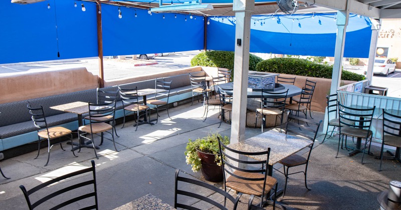 Covered exterior seating area, tables, chairs, plants