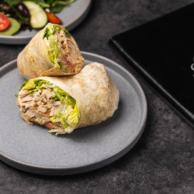 Caesar Salad Wrap cut in half and served.