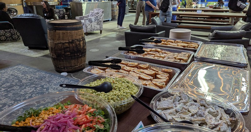 Food in various serving containers on an open table