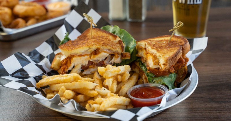 Buffalo Chicken Club sandwich, served with fries and a dip