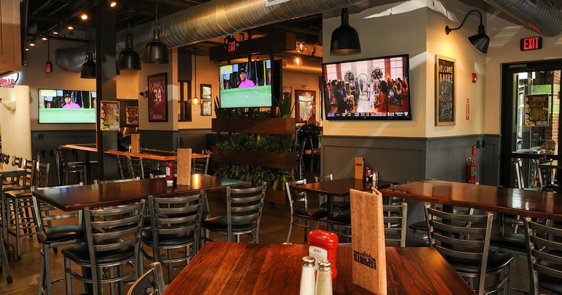 Interior, guest tables and chairs, wall TV screens