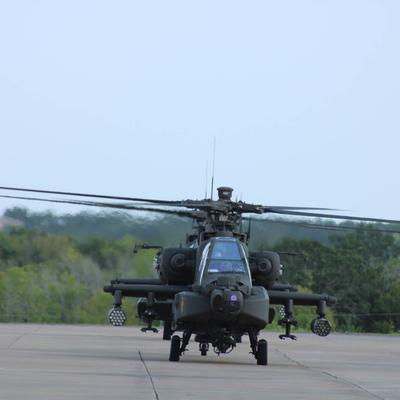 An Apache helicopter on a runway.