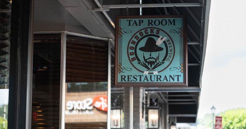 Boondocks Tap Room and Restaurant sign hanging outside a storefront