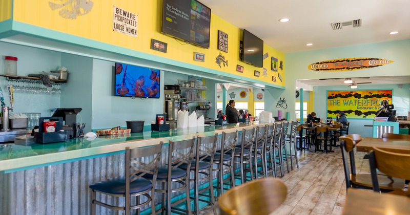 Interior, bar, bar stools in line,  beer taps behind, tv screens above