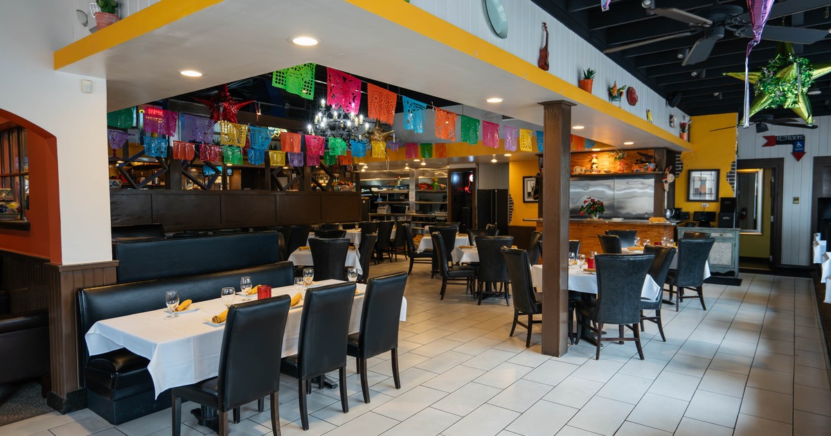 Interior of a festive restaurant with colorful banners hanging from the ceiling