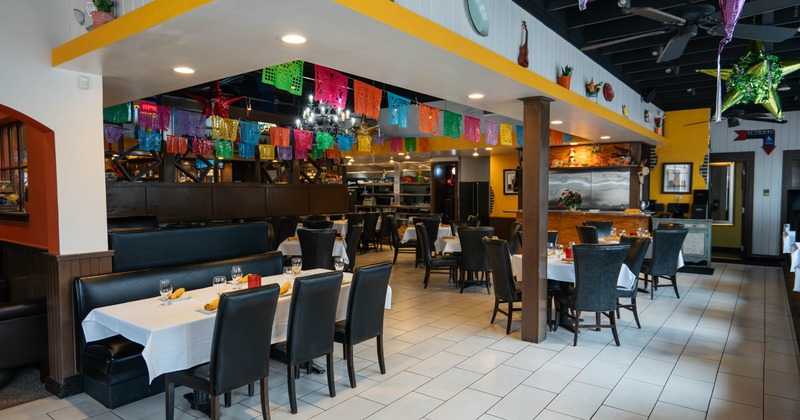 Interior of a festive restaurant with colorful banners hanging from the ceiling