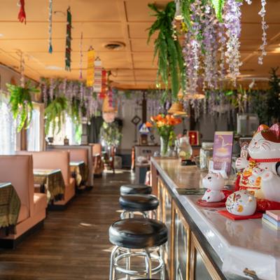 Booths on a left, bar and stools on the right side.