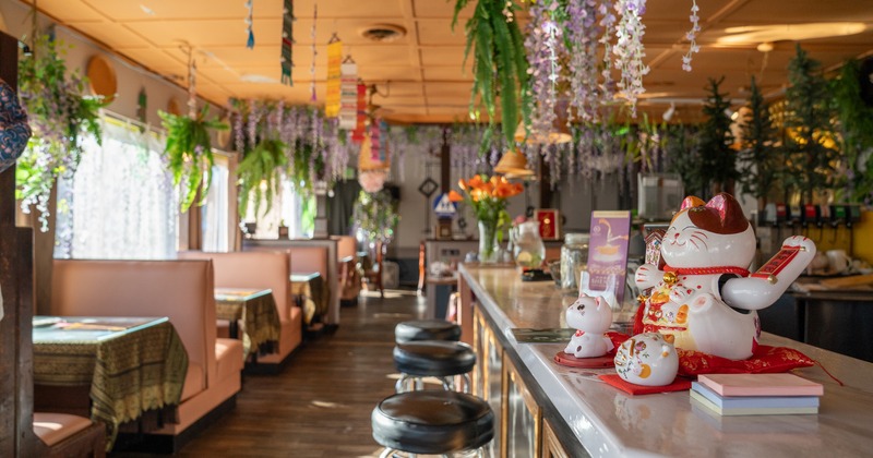 Booths on a left, bar and stools on the right side
