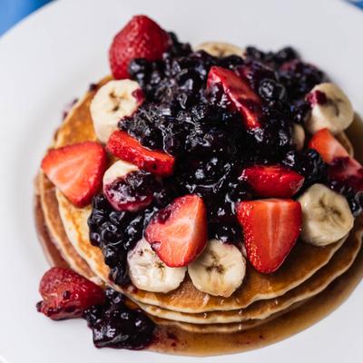 Flapjack pancakes topped with fruit.