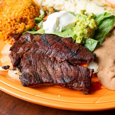 Carne Asada with sides of rice, beans, guacamole and sour creme.