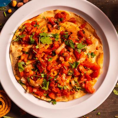 Indian lentil wafers roasted or spiced with onions, fresh tomato and cilantro
