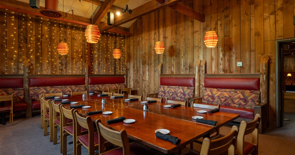 Interior, private area with big wooden table ready for guests