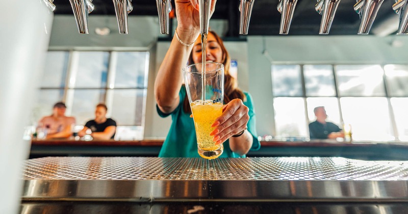 Bartender pouring a glass of beer