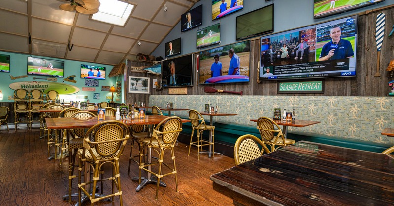 Interior, seating area with TVs on the walls