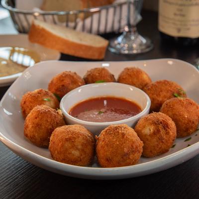 Arancini balls, stuffed with meat sauce, peas, and mozzarella.