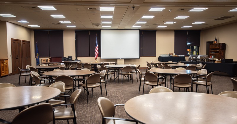 Hall for presentations, celebrations and diner, tables and chairs, video screen