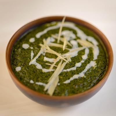 Spinach puree with cubes of paneer cheese.