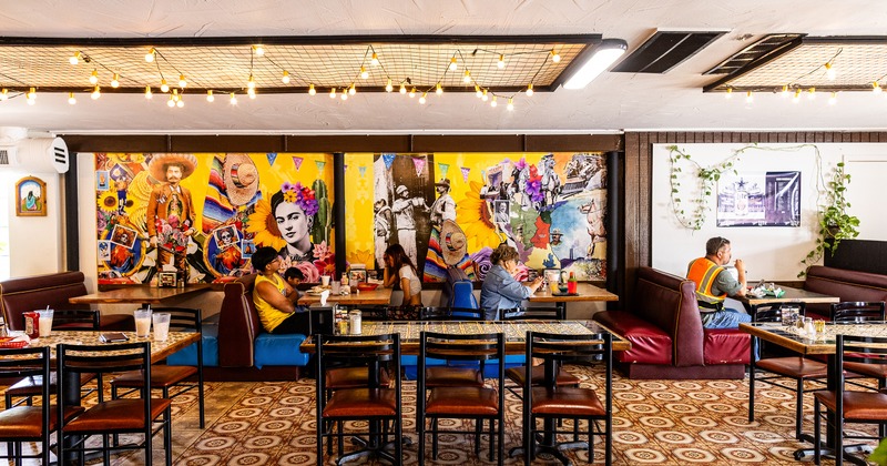 Vivid interior dining area of Mexican restaurant with guests enjoying their food