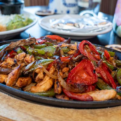 Fajitas served on the table with other dishes.