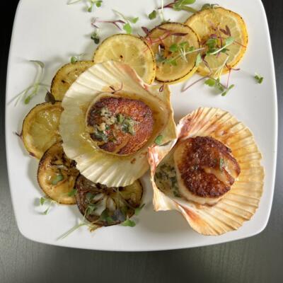 seared scallops, lemon and herbs in the shell.